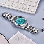 PAGANI DESIGN PD-1733 Oyster NH35A automatic watch with teal dial laid flat with steel bracelet