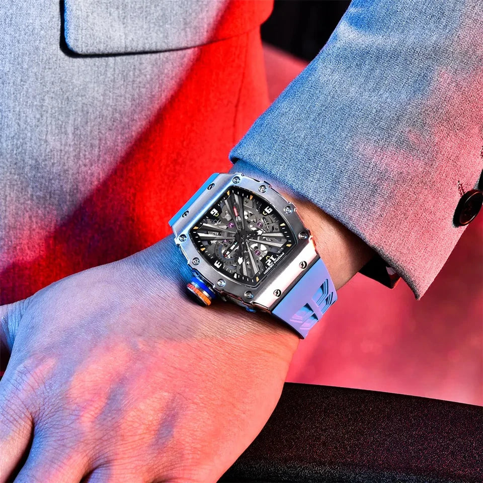 PAGANI DESIGN PD-1738 MILLE skeleton watch with blue rubber strap worn on wrist with suit