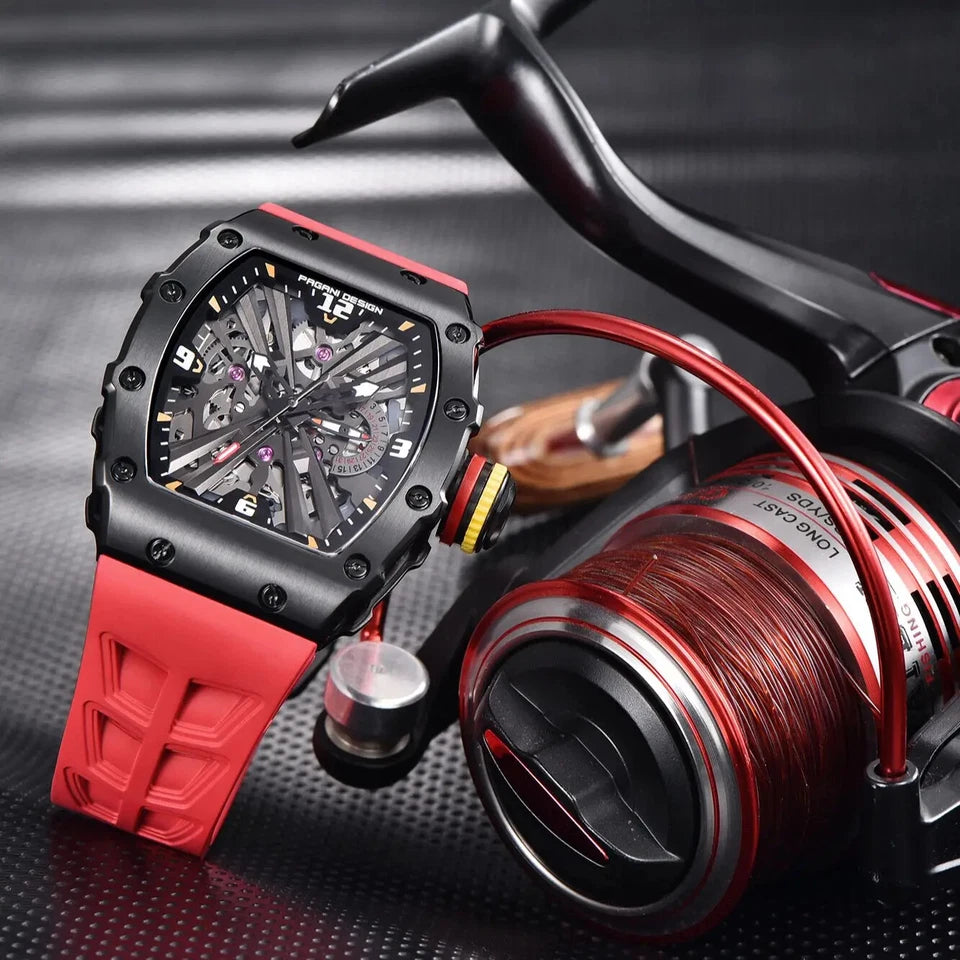 PAGANI DESIGN PD-1738 MILLE skeleton watch with red rubber strap beside fishing reel prop