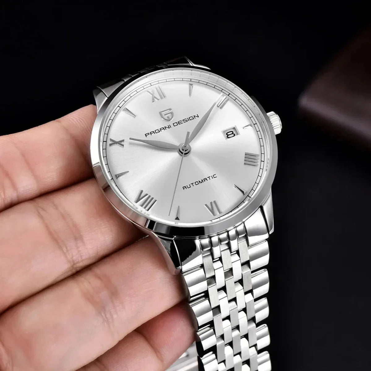 Pagani Design PD-1759 silver dial ultra-thin automatic held in hand, Roman numerals and date window