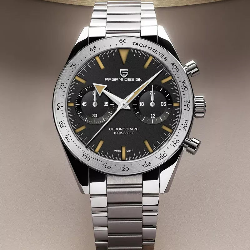 Angled view of Pagani Design PD-1766 men's moon quartz chronograph watch with a black dial, gold-tone markers, chronograph subdials, tachymeter bezel, stainless steel case, and matching stainless steel bracelet on a champagne background.