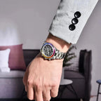 Pagani Design PD-1777 rainbow bezel skeleton watch worn with a grey suit sleeve