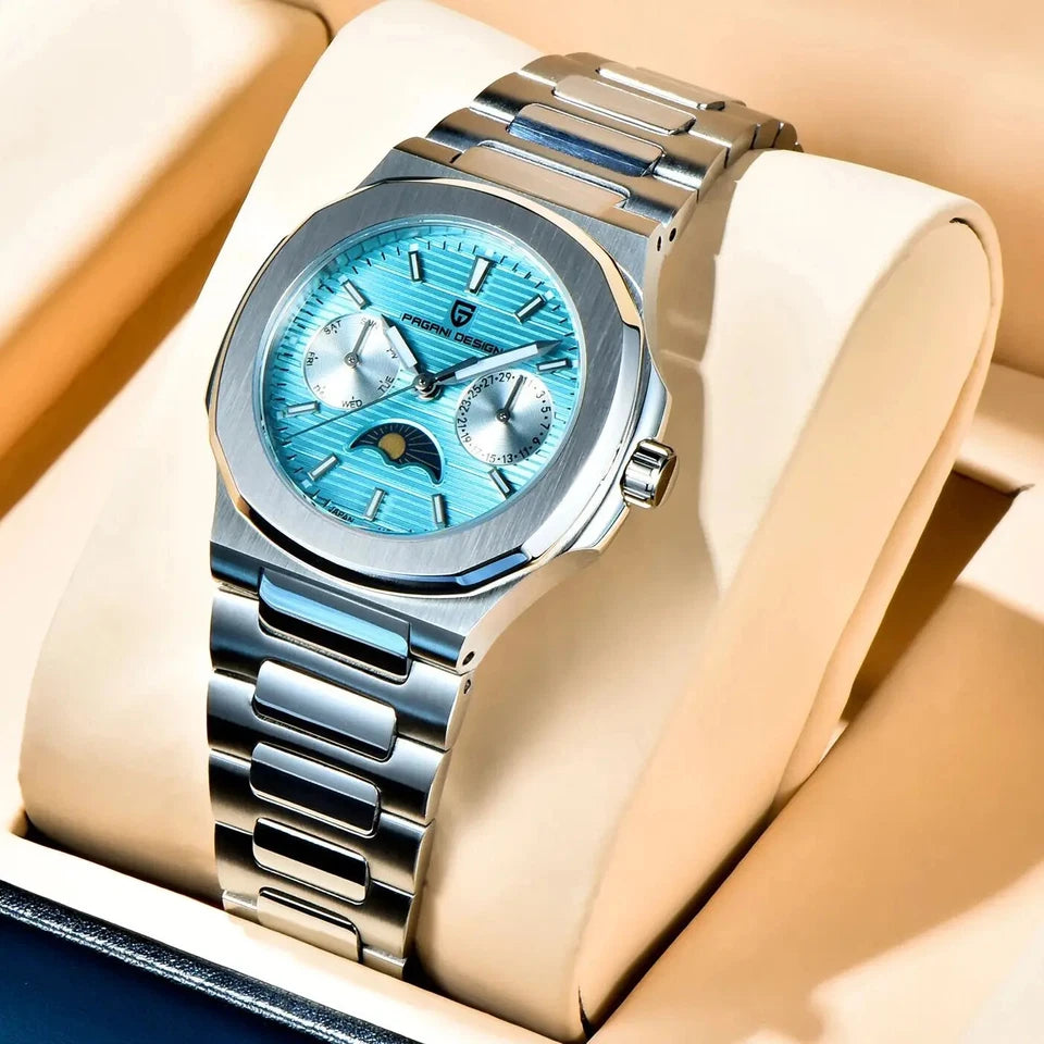 Lifestyle display photo of Pagani Design PD-1786 quartz watch with blue dial and moonphase subdial, stainless steel bracelet, silver case, resting on a beige cushion display.