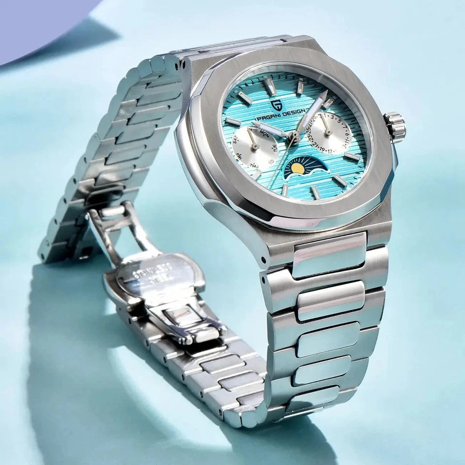 Side view of Pagani Design PD-1786 quartz chronograph watch with blue dial and moonphase subdial, stainless steel bracelet and silver case, displayed with open clasp on light blue background.