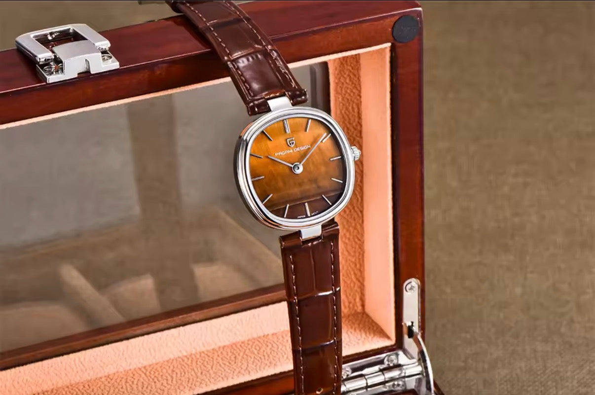 Pagani Design PD-1825 amber tiger's eye dial angled against a wooden watch box lid