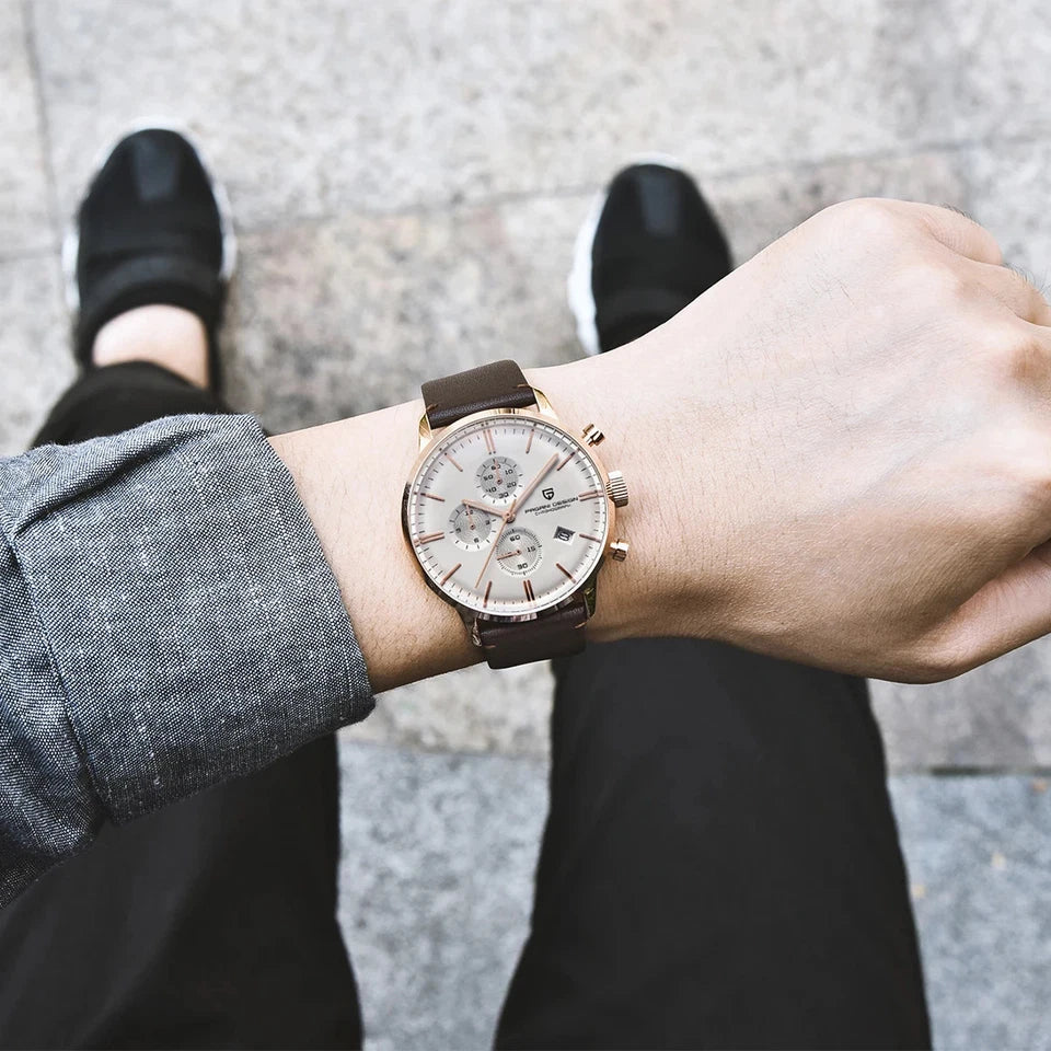 Wrist shot of Pagani Design PD-2720K chronograph watch white dial rose gold case brown leather strap worn with grey cuff