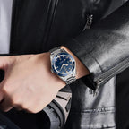 PAGANI DESIGN PD-YS005 automatic watch with blue dial silver bracelet worn on wrist with leather jacket