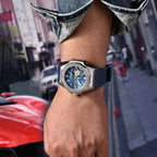 Man wearing PAGANI DESIGN PD-YS010 watch with blue dial and strap on city street with red car