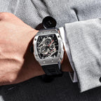 Man wearing PAGANI DESIGN PD-YS012 tonneau skeleton watch with black dial and rubber strap