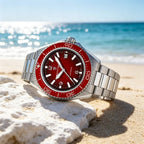 Pagani Design PD-YS034 red dial diver on steel bracelet photographed on beach coral by the sea