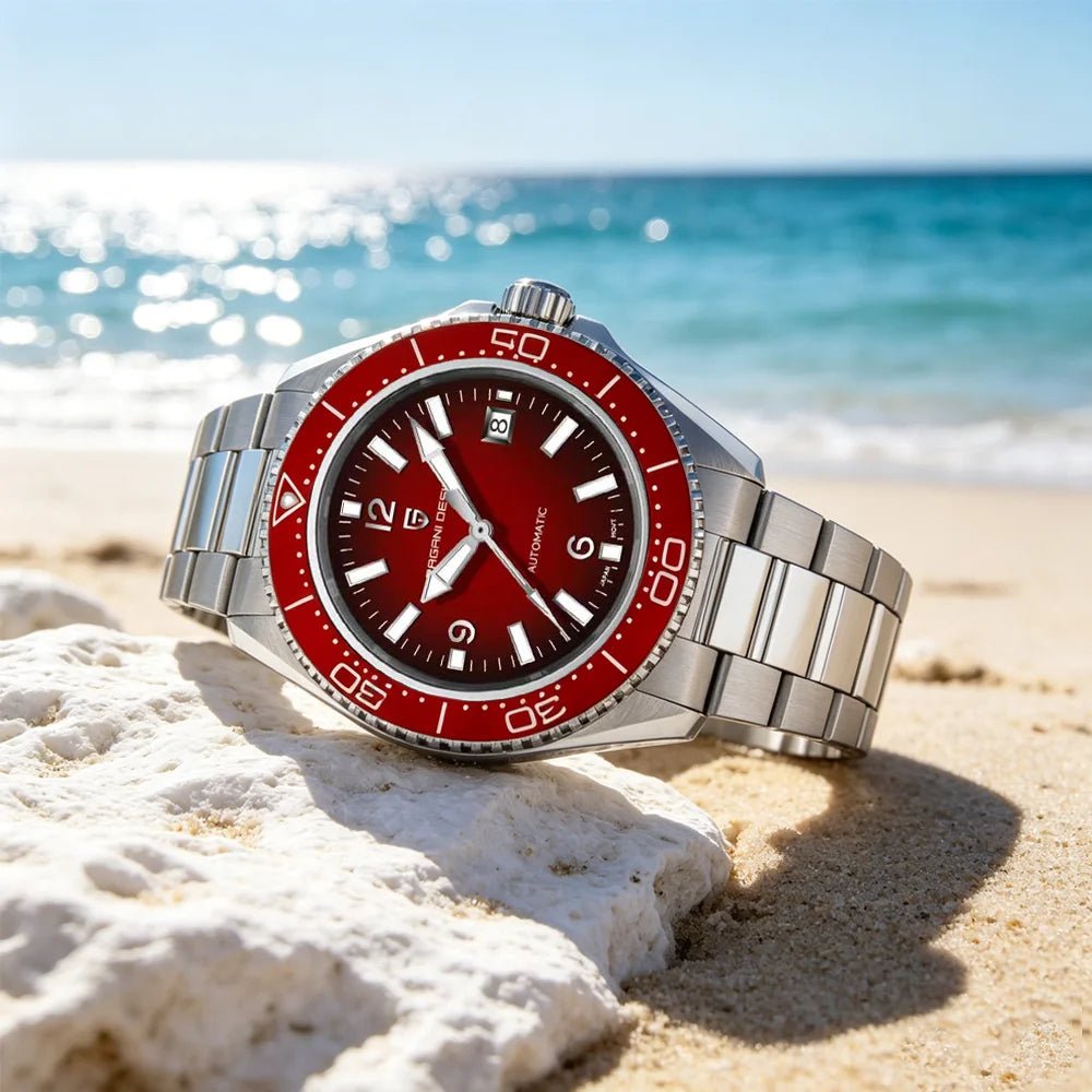 Pagani Design PD-YS034 red dial diver on steel bracelet photographed on beach coral by the sea
