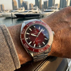 Pagani Design PD-YS034 red dial on wrist with steel bracelet, sunburst finish shown in daylight