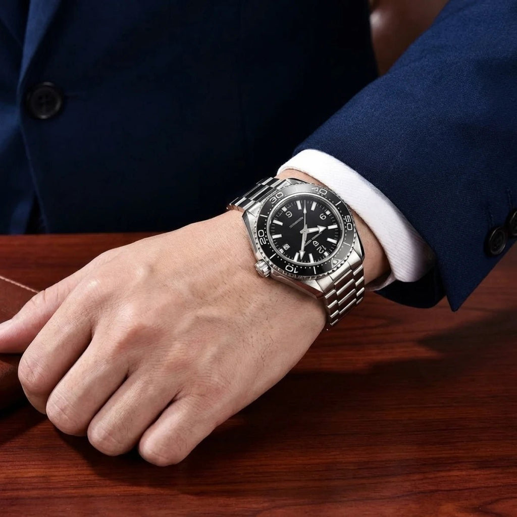 Pagani Design PD-YS034 black dial on wrist at a desk, showing steel bracelet drape and low profile