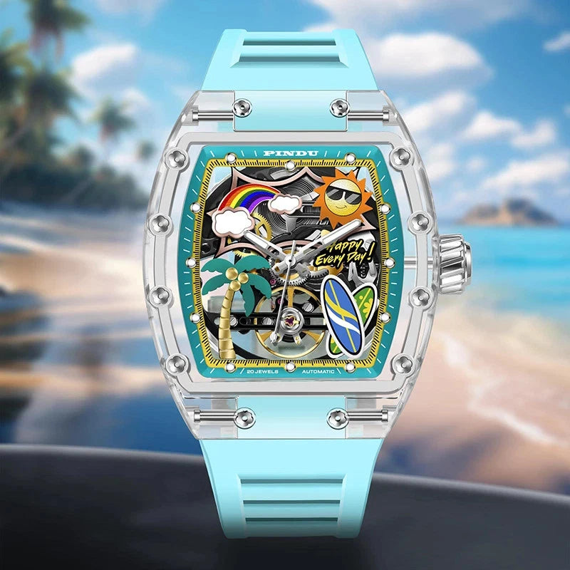Pindu Summer Beach tonneau mechanical watch with tropical skeleton dial, clear resin case and sky blue silicone strap, photographed against a blurred seaside background.