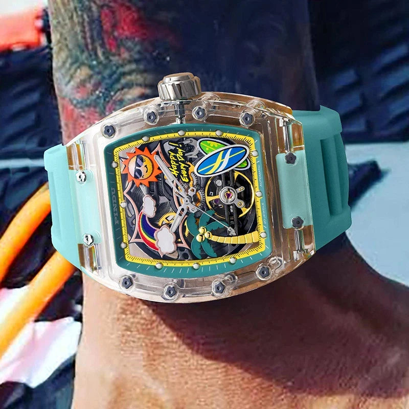 Wrist shot of PINDU 6633 Summer Beach tonneau mechanical watch featuring a tropical skeleton dial, transparent resin case, and turquoise silicone strap, worn on a tattooed wrist.