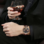 PINDU M2791B Godfather skeleton watch on wrist of man holding cognac glass, lifestyle