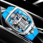 PINDU P5023 steel tonneau watch with cyan strap resting on a car wheel, engine skeleton dial