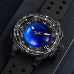 PINDU P6676 Planet blue domed dial in black 48mm case, laid flat on navy suede with black silicone strap curled behind