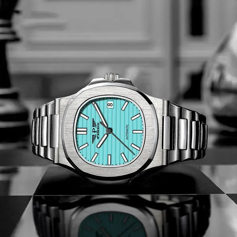 PINDU PD6502 turquoise-dial steel watch standing on a reflective black surface in a styled shot