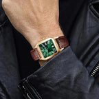 PINDU PD6515 men's automatic watch with green dial and brown leather strap worn on wrist over leather jacket