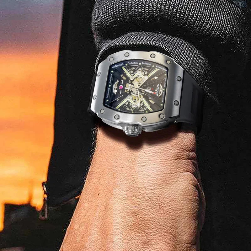 Wrist shot of Pindu PD6550 wine barrel mechanical watch featuring skeleton dial, stainless steel case, black silicone strap, against a sunset background