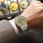 POEDAGAR 1416 automatic tourbillon watch with two-tone case and bracelet on wrist near display