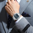 POEDAGAR 672 mens square waterproof watch with blue dial and silver steel bracelet worn on wrist