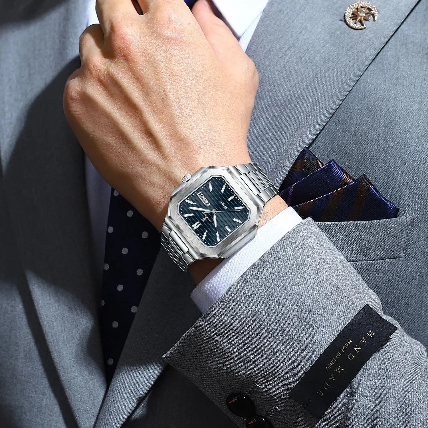 POEDAGAR 672 mens square waterproof watch with blue dial and silver steel bracelet worn on wrist