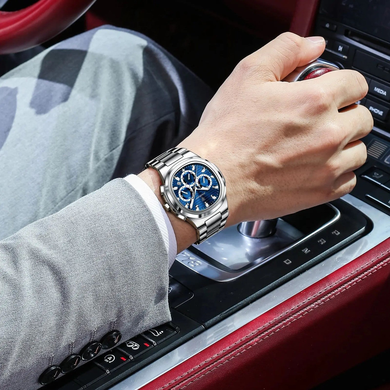 POEDAGAR 834 mens chronograph with blue dial and steel bracelet on wrist while driving car
