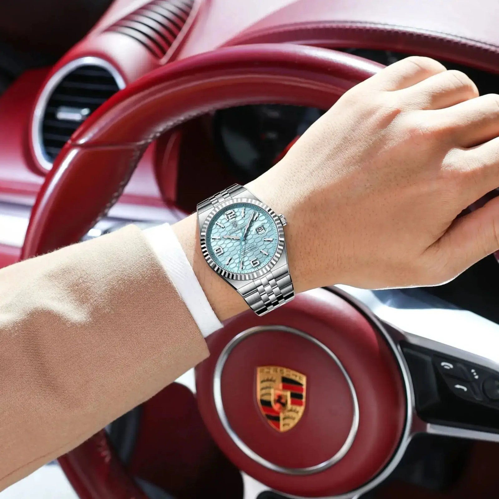 POEDAGAR 839 mens quartz waterproof watch with ice blue dial and steel bracelet on wrist with Porsche wheel