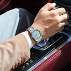 POEDAGAR 839 mens quartz waterproof with ice blue dial and steel bracelet on wrist on car gear shift