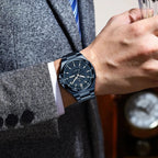 POEDAGAR 896 men's sport quartz watch with blue dial worn on wrist holding glass with grey suit