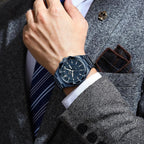 POEDAGAR 896 men's sport quartz watch with blue dial worn on wrist while adjusting striped tie