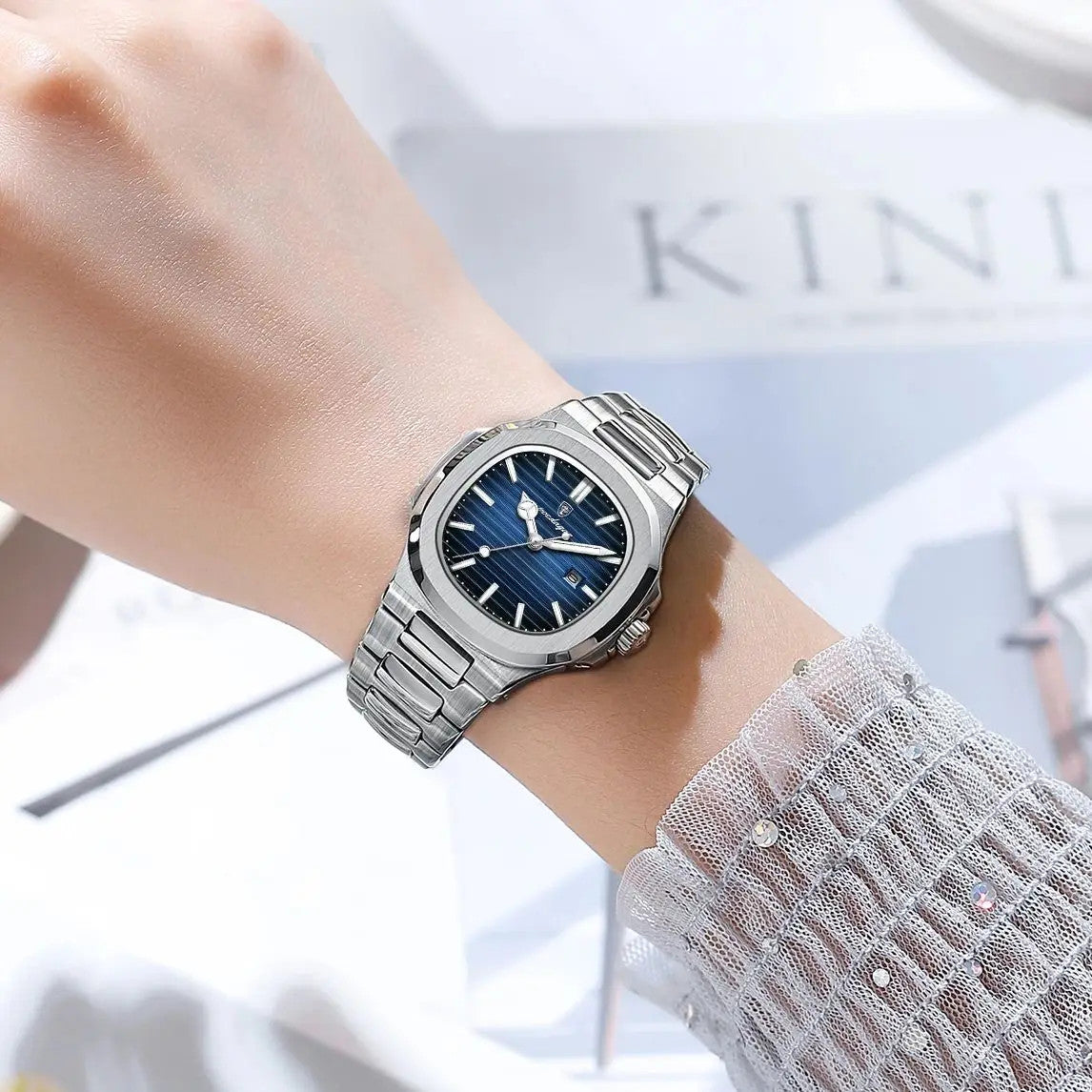 POEDAGAR women's quartz watch with blue dial and steel bracelet on wrist with sheer sleeve