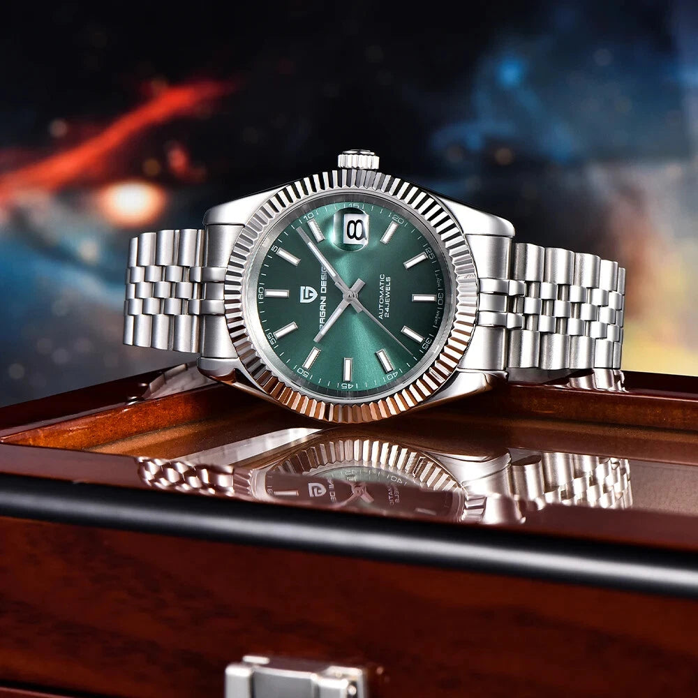Silver watch with green face on a reflective surface with a blurred background