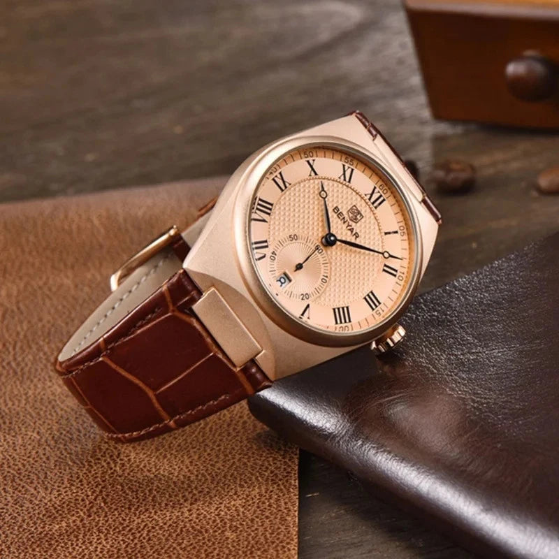 Rose gold watch with brown leather strap on a textured surface