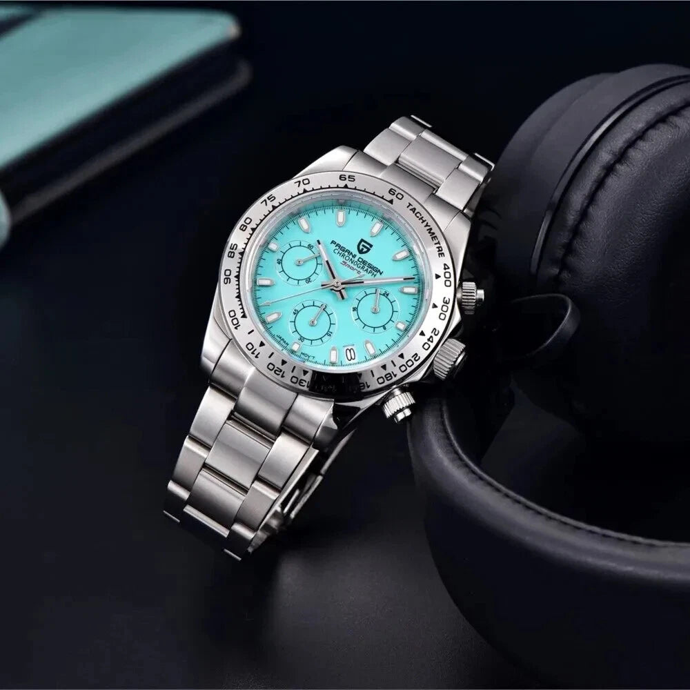 Silver wristwatch with a turquoise dial on a dark surface