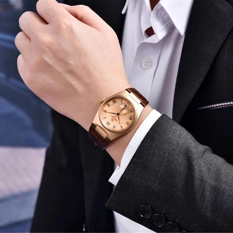 Rose gold watch on a person's wrist with a blurred background