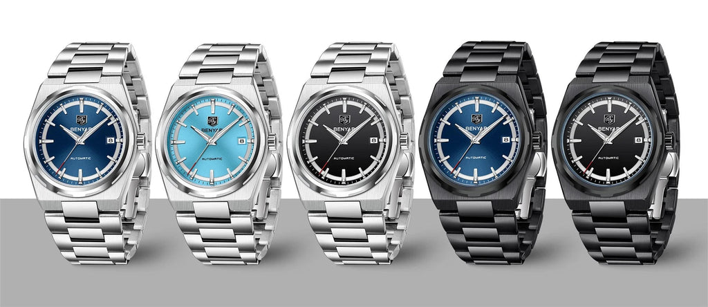 Five watches with different colored faces and metallic bands on a gray background