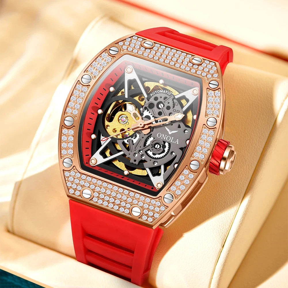 Luxury watch with red strap and rose gold case on a beige surface