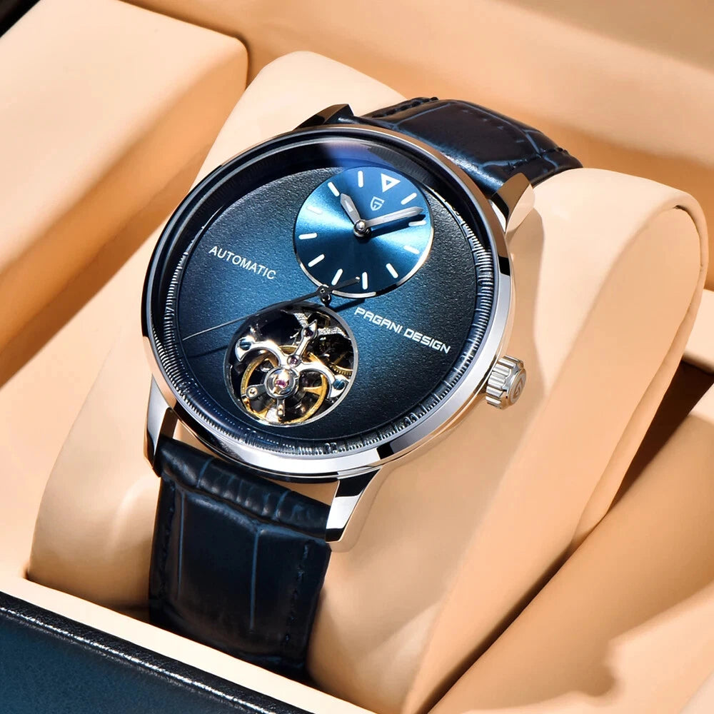 Luxury watch with blue face and black leather strap in a beige box
