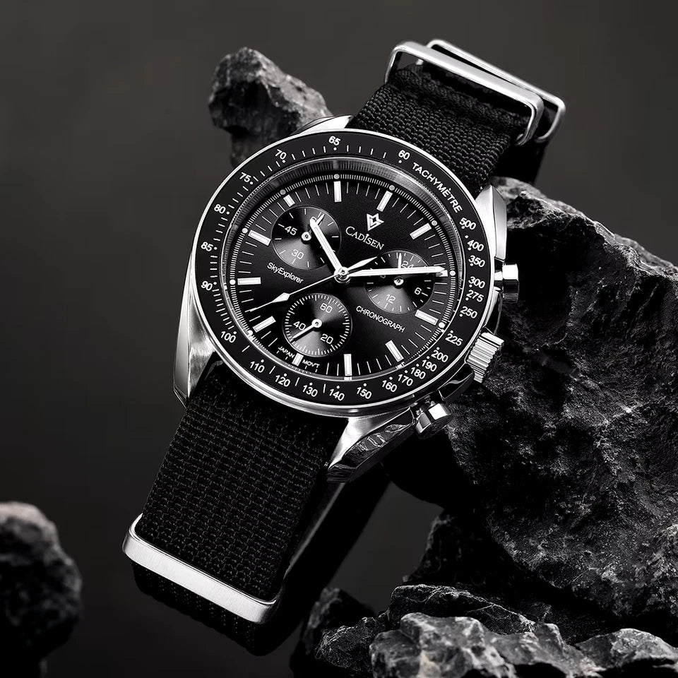 Black wristwatch with detailed face on a rocky background