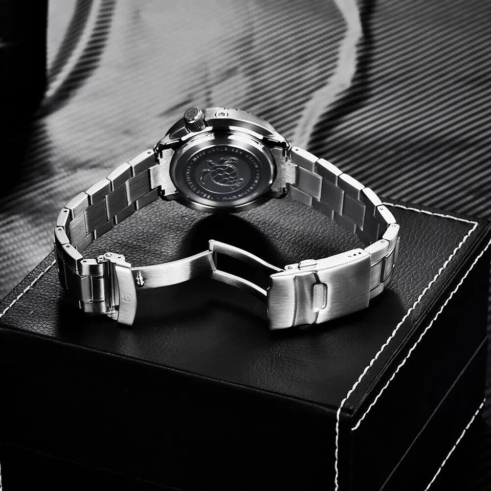 Silver watch with metal band on a textured surface