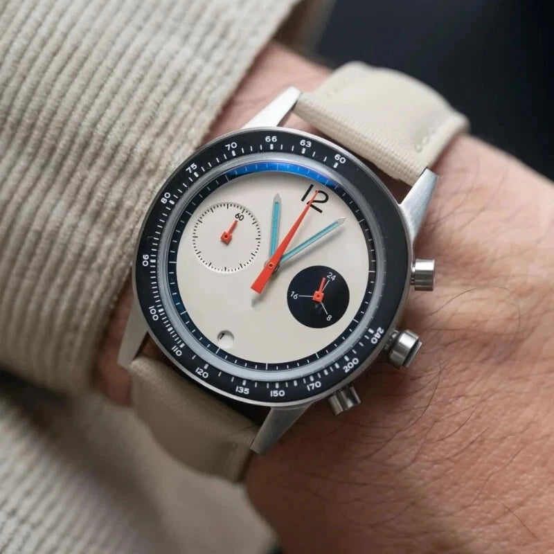 Close-up of a wrist wearing a detailed wristwatch with a beige strap.