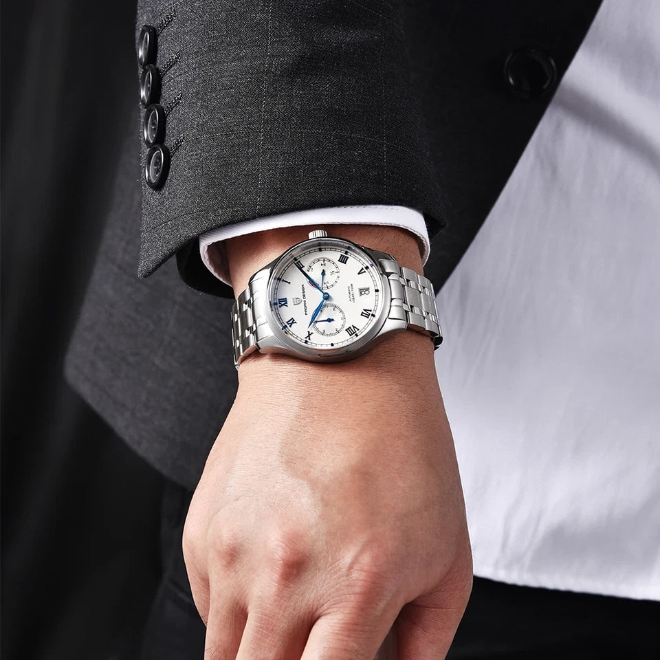 Silver wristwatch on a person's wrist with a suit sleeve