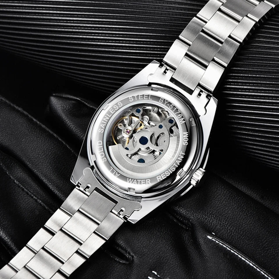 Silver watch with mechanical components on a black textured background