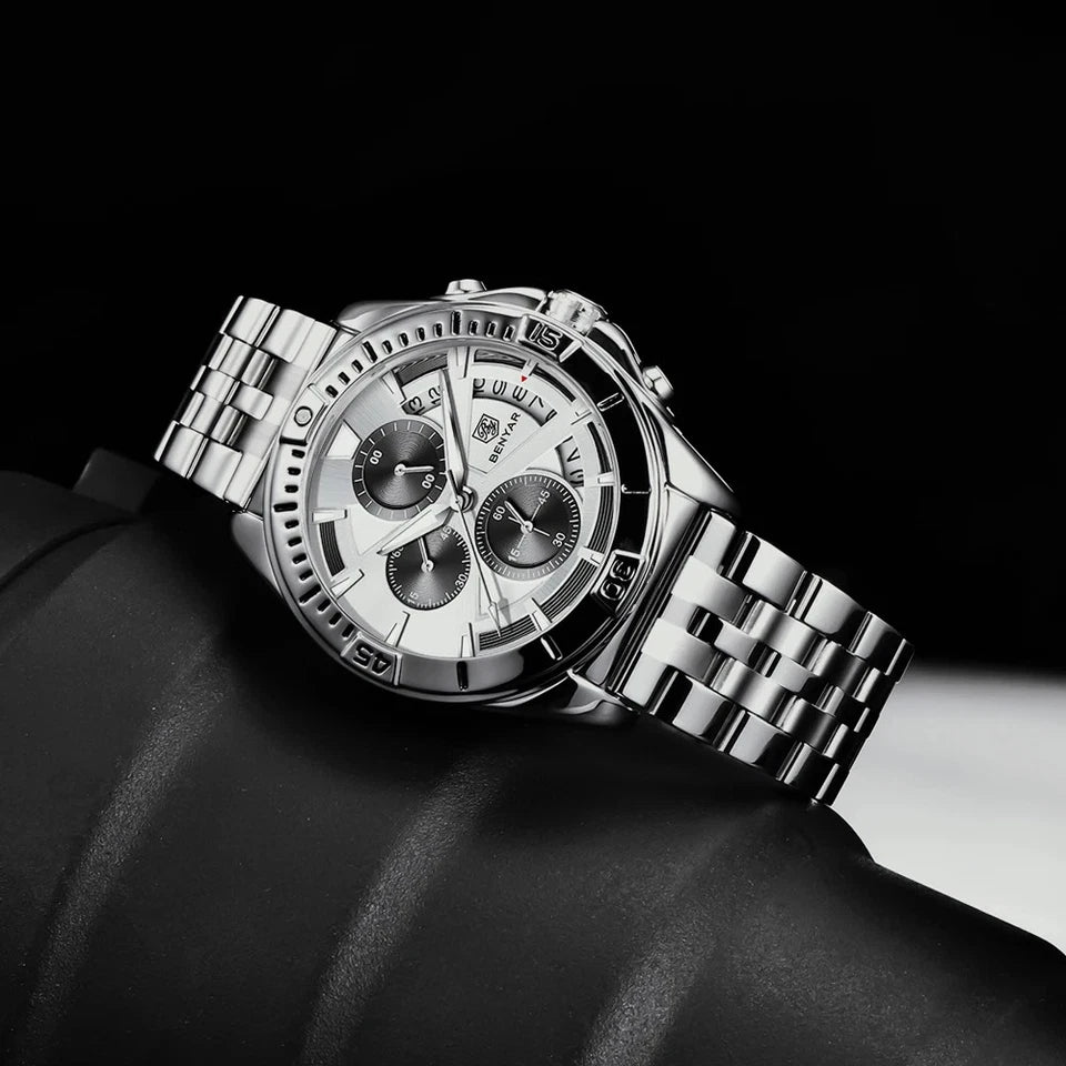 Silver wristwatch with detailed face on a dark background