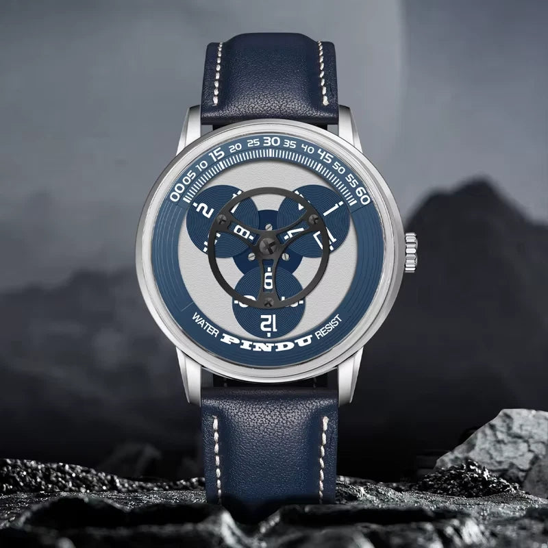 Watch with blue strap and unique dial design on a rocky surface