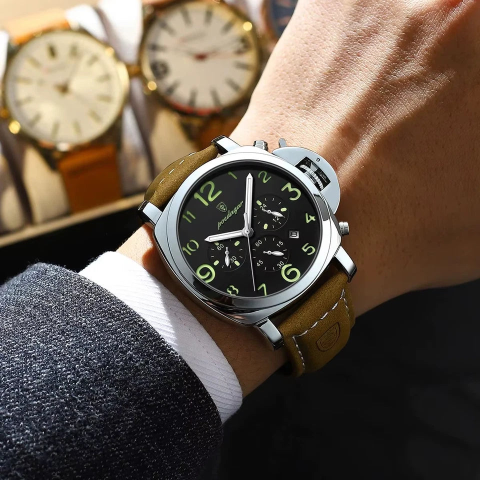 Close-up of a wrist wearing a watch with a dark face and brown leather strap, with a blurred background of other watches.