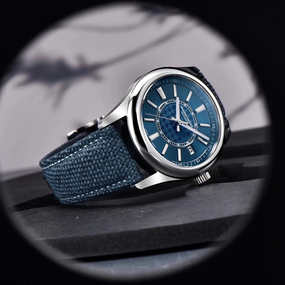 Blue wristwatch with a textured strap on a dark surface